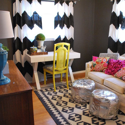 Inspiration for an eclectic freestanding desk medium tone wood floor home office remodel in Other with black walls