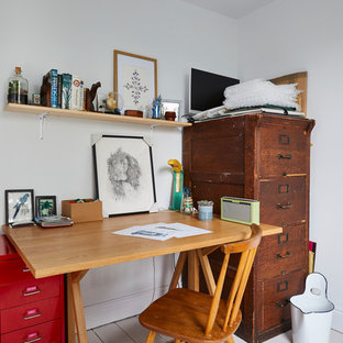 Design ideas for a bohemian study in Surrey with white walls, painted wood flooring, a freestanding desk and white floors.