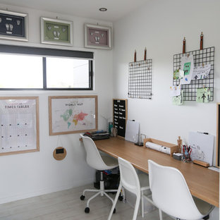 This is an example of a contemporary home office in Gold Coast - Tweed with white walls, light hardwood floors, a built-in desk and beige floor.