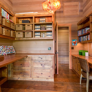 Example of a large mountain style built-in desk medium tone wood floor craft room design in Seattle