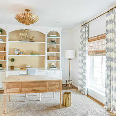 Study room - mid-sized transitional freestanding desk medium tone wood floor and brown floor study room idea in Houston with white walls