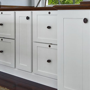 Example of a mid-sized classic built-in desk dark wood floor study room design in Boston with blue walls and no fireplace