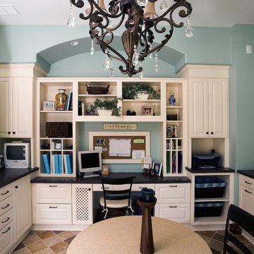 Family workshop/home office with custom built-in cabinetry, wrapping station, an