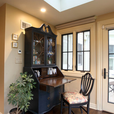 Small farmhouse freestanding desk medium tone wood floor study room photo in New York with beige walls