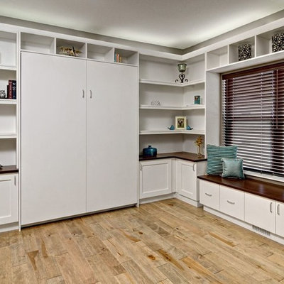 Home office - large contemporary built-in desk light wood floor and brown floor home office idea in Minneapolis with beige walls and no fireplace