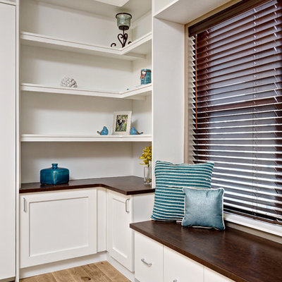 Example of a large trendy built-in desk light wood floor and brown floor home office design in Minneapolis with beige walls and no fireplace
