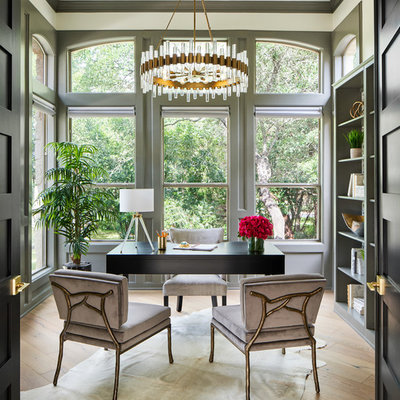 Home office library - mid-sized transitional freestanding desk light wood floor and gray floor home office library idea in Austin with gray walls