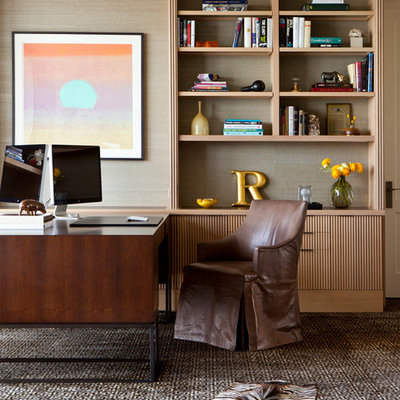 Example of a large trendy freestanding desk carpeted study room design in Austin with beige walls and no fireplace
