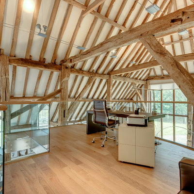 Inspiration for a country freestanding desk light wood floor study room remodel in Other with white walls