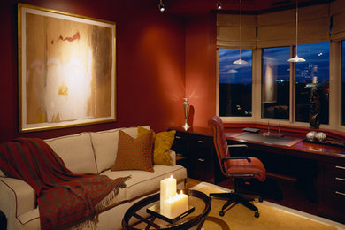 Imagen de despacho tradicional con paredes rojas y escritorio empotrado