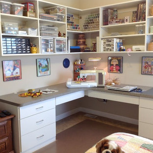 Example of a mid-sized trendy built-in desk craft room design in Other with white walls and no fireplace