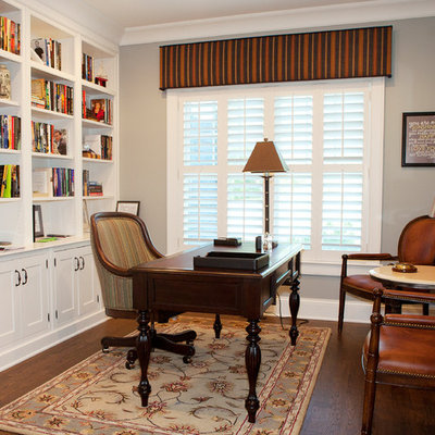 Example of a mid-sized classic freestanding desk dark wood floor and brown floor study room design in Chicago with gray walls and no fireplace