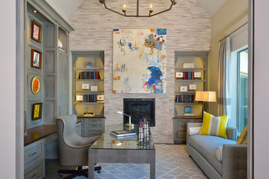 Study room - mid-sized transitional freestanding desk medium tone wood floor and gray floor study room idea in Houston with gray walls, a standard fireplace and a stone fireplace