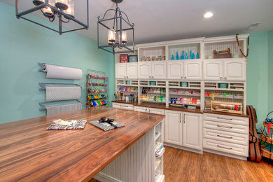Craft room - large traditional medium tone wood floor craft room idea in St Louis with blue walls