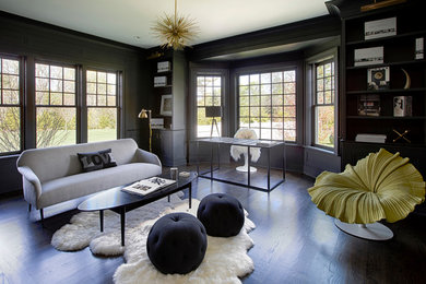 Example of a large transitional freestanding desk dark wood floor study room design in New York with black walls