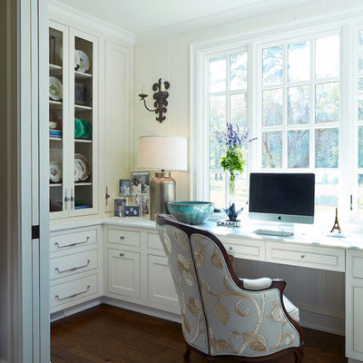Mid-sized elegant built-in desk dark wood floor home office photo in Birmingham with white walls