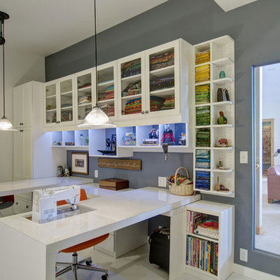 Inspiration for a mid-sized transitional built-in desk porcelain tile and white floor craft room remodel in Denver with gray walls and no fireplace
