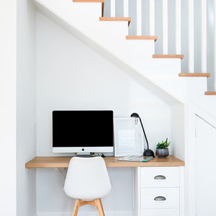 Design ideas for a small beach style study room in Sydney with white walls, a built-in desk, light hardwood floors and no fireplace.