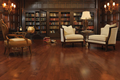 Large elegant dark wood floor home office library photo in Toronto with brown walls and no fireplace