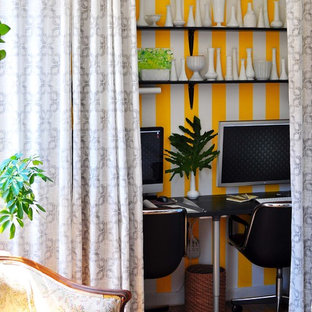 Inspiration for an eclectic medium tone wood floor home office remodel in New York with multicolored walls