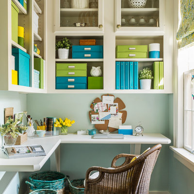 Inspiration for a mid-sized transitional built-in desk dark wood floor craft room remodel in Little Rock with blue walls and no fireplace