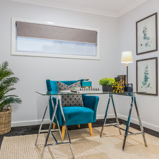 This is an example of a beach style study room in Brisbane with grey walls, a freestanding desk and no fireplace.