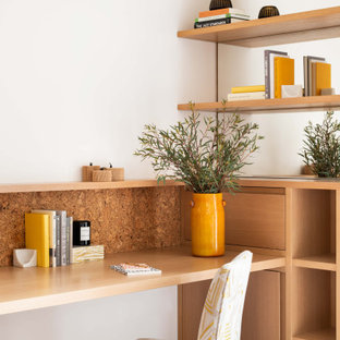 Photo of a contemporary home office in London with white walls, carpet, a built-in desk and grey floors.