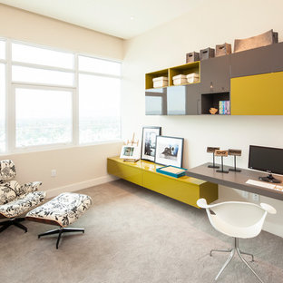 Inspiration for a contemporary built-in desk carpeted and gray floor home office remodel in Los Angeles with beige walls