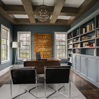 Inspiration for a large transitional freestanding desk dark wood floor and brown floor study room remodel in Houston with blue walls and no fireplace