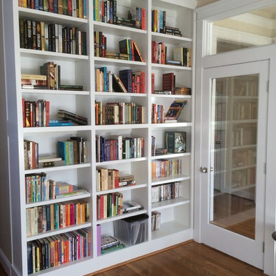 Home office library - small transitional medium tone wood floor and brown floor home office library idea in Charlotte with beige walls and no fireplace