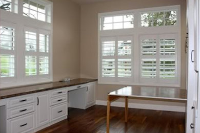 Home office in Orlando with beige walls and dark hardwood flooring.
