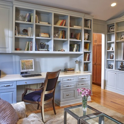 Mid-sized elegant built-in desk medium tone wood floor study room photo in San Francisco with blue walls