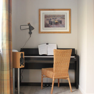Inspiration for a medium sized contemporary home office in West Midlands with grey walls, laminate floors and beige floors.