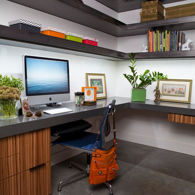 Example of a mid-sized trendy built-in desk concrete floor home office design in Other with white walls and no fireplace