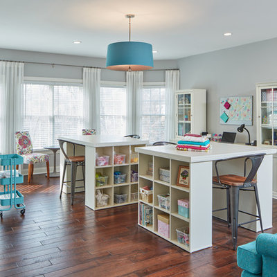 Example of a large classic freestanding desk medium tone wood floor craft room design in Baltimore with gray walls