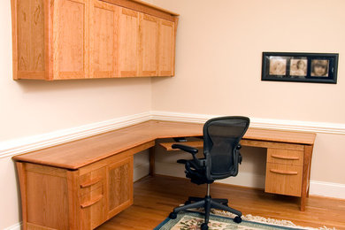 Study room - mid-sized contemporary freestanding desk light wood floor study room idea in Raleigh with beige walls