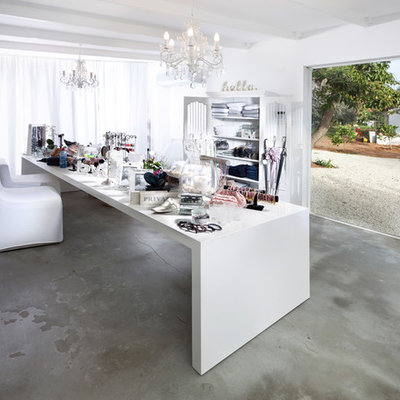 Inspiration for an eclectic concrete floor and gray floor craft room remodel in Other