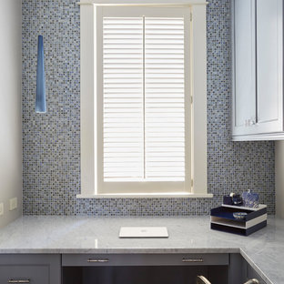 Example of a small classic built-in desk dark wood floor and brown floor study room design in Chicago with blue walls