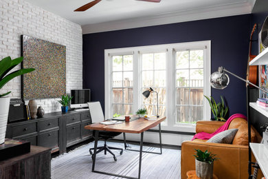 Design ideas for an eclectic home office in Atlanta with black walls and dark hardwood flooring.