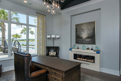 Example of a mid-sized trendy home office design in Tampa with gray walls and a two-sided fireplace