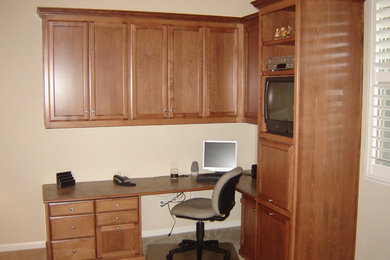 Example of a small classic built-in desk carpeted study room design in San Luis Obispo with beige walls