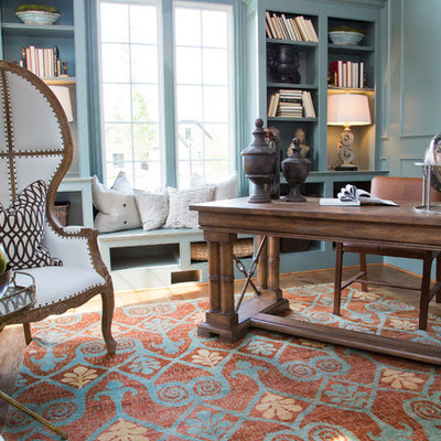 Transitional freestanding desk medium tone wood floor and brown floor study room photo in Louisville with blue walls