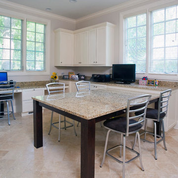 Home office with large work table topped in granite