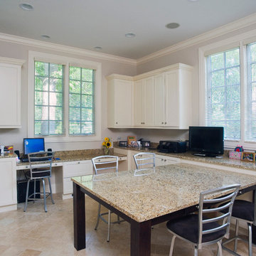 Home office with large work table topped in granite