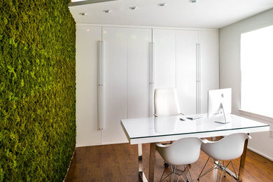 Idee per un piccolo ufficio design con pareti bianche, pavimento in legno massello medio e scrivania autoportante