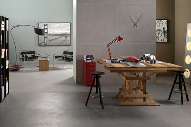 Imagen de despacho moderno con paredes grises, suelo de baldosas de porcelana y escritorio independiente
