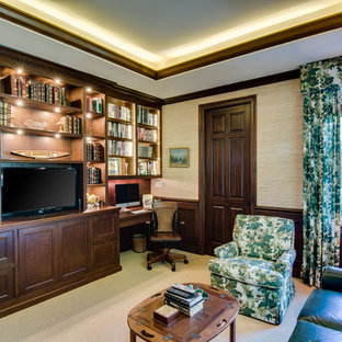 Home office - built-in desk carpeted home office idea in Miami with no fireplace