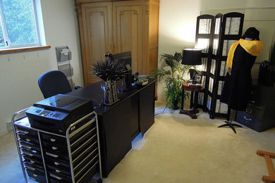 Mid-sized elegant freestanding desk carpeted study room photo in Vancouver with white walls