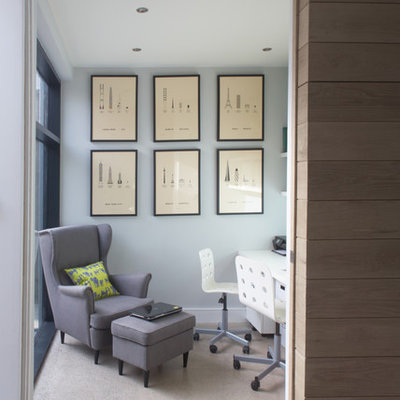 Example of a trendy built-in desk concrete floor home office design in Dublin with gray walls