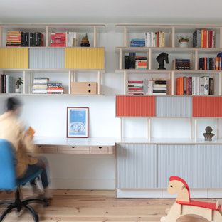 Design ideas for a scandinavian home office in London with a reading nook, white walls, light hardwood flooring, no fireplace and a built-in desk.
